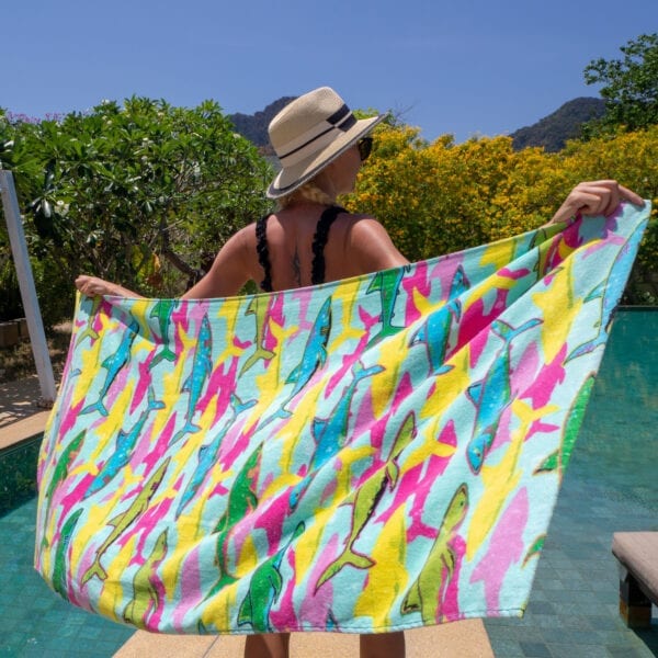 Woman holding Printed Beach Towels - Shark by the pool