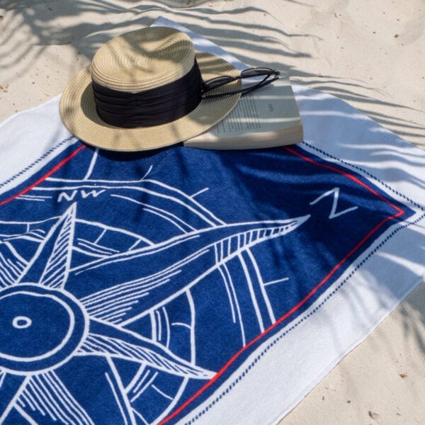 Beach hat and book on a Printed Beach Towel - Compass