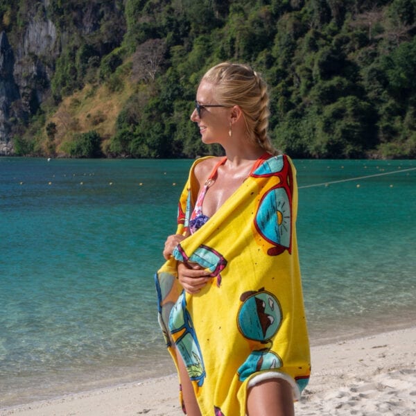 Woman wrapped in Printed Beach Towel - Sunglasses by the ocean